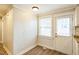 Dining area with wood-look flooring, ample light, and access to the backyard at 2400 Dorety Pl, Raleigh, NC 27604