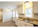 Bright kitchen featuring granite countertops and white cabinets at 2400 Dorety Pl, Raleigh, NC 27604
