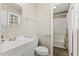 Bathroom with white fixtures, a shower/tub, and a dark, durable floor at 2400 Keith Dr, Raleigh, NC 27610