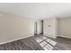 Spacious bedroom with wood-look floors, walk-in closets, white trim, and a neutral color palette at 2400 Keith Dr, Raleigh, NC 27610