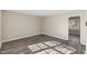 An empty bedroom with light-colored walls, sleek wood-look flooring, and bright natural light at 2400 Keith Dr, Raleigh, NC 27610