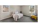 Bright bedroom with two windows, neutral walls, and comfortable furniture at 2400 Keith Dr, Raleigh, NC 27610