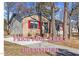 Charming brick and siding home featuring bright red shutters and manicured landscaping at 2400 Keith Dr, Raleigh, NC 27610