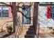 A close up of a brick home's front door entry featuring black iron railings and red shutters at 2400 Keith Dr, Raleigh, NC 27610