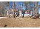 Charming single-story home featuring a brick facade, bright red shutters, and mature trees at 2400 Keith Dr, Raleigh, NC 27610
