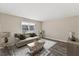 A bright, neutrally decorated living room featuring stylish furnishings and wood-look floors at 2400 Keith Dr, Raleigh, NC 27610