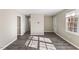 Living room with stylish wood-look floors, natural light, and neutral paint at 2400 Keith Dr, Raleigh, NC 27610