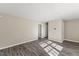 Spacious living area with modern wood-look floors, a large window, and neutral walls at 2400 Keith Dr, Raleigh, NC 27610