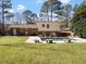 Spacious backyard with lush green grass, mature trees, and a refreshing in-ground swimming pool at 2509 Foxgate Dr, Raleigh, NC 27610