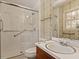 Bathroom featuring a glass-enclosed shower, a vanity with sink, and decorative wallpaper at 2509 Foxgate Dr, Raleigh, NC 27610