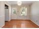The dining area features hardwood floors, decorative wallpaper, and a window with curtains at 2509 Foxgate Dr, Raleigh, NC 27610