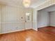 Dining room with hardwood flooring, decorative wallpaper, and chandelier lighting at 2509 Foxgate Dr, Raleigh, NC 27610