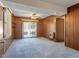 Cozy living area with paneled walls, carpet, and sliding glass doors to the exterior at 2509 Foxgate Dr, Raleigh, NC 27610