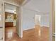 View of living space with hardwood floors and an open doorway to the kitchen at 2509 Foxgate Dr, Raleigh, NC 27610