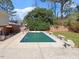 Backyard in-ground pool, surrounded by a concrete pool deck, and a grassy lawn at 2509 Foxgate Dr, Raleigh, NC 27610