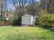 Backyard shed for extra storage on a verdant lot with mature trees and landscaping at 2509 Foxgate Dr, Raleigh, NC 27610