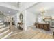 Bright and airy entryway with hardwood floors and a view of the staircase and living area at 2720 Stratford Hall Dr, Raleigh, NC 27614