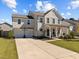 Two-story house with gray siding, porch, and rocking chairs at 2808 Raddercrest Ct, Fuquay Varina, NC 27526