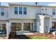 Backyard view featuring a small patio, a sliding glass door, and a grassy area at 307 Walnut Woods Dr, Morrisville, NC 27560