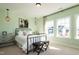 Charming bedroom with light green walls and metal bed frame at 3142 Armeria Dr, Apex, NC 27502