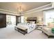 Primary bedroom with barn doors leading to sitting area at 3142 Armeria Dr, Apex, NC 27502