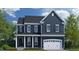 Two-story home with navy siding, white trim, and a two-car garage at 3142 Armeria Dr, Apex, NC 27502