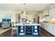 Modern kitchen with large island, stainless steel appliances, and wine storage at 3142 Armeria Dr, Apex, NC 27502