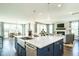 Open concept kitchen with large island and a farmhouse sink at 3142 Armeria Dr, Apex, NC 27502