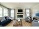 Bright living room features a cozy fireplace and hardwood floors at 3142 Armeria Dr, Apex, NC 27502