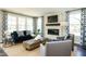 Comfortable living room includes a fireplace and large windows at 3142 Armeria Dr, Apex, NC 27502