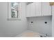 Bright laundry room with upper cabinets and window at 3406 Sir Colleton Ct, Raleigh, NC 27612