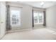 Neutral bedroom with large windows and a ceiling fan at 3932 Bentley Bridge Rd, Raleigh, NC 27612