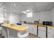 Small basement kitchenette with white cabinets and wood countertop at 415 Englewood Ave, Durham, NC 27701