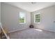 Spacious bedroom with two windows and neutral decor at 423 Potter St, Durham, NC 27701