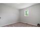 Simple bedroom with a window and neutral-colored walls at 423 Potter St, Durham, NC 27701