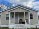 Tan house with white trim, steps, and porch at 423 Potter St, Durham, NC 27701