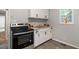 Modern kitchen with white cabinets and butcher block countertops at 423 Potter St, Durham, NC 27701