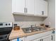 Updated kitchen featuring stainless steel appliances and a double sink at 423 Potter St, Durham, NC 27701