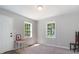 Spacious living room with two windows and neutral decor at 423 Potter St, Durham, NC 27701