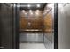 Modern elevator with wood and metal finishes at 500 N Duke St # 56-207, Durham, NC 27701