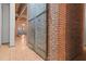 Hallway with exposed brick and metal doors at 500 N Duke St # 56-207, Durham, NC 27701