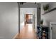 Long hallway with wood floors offering views to living area at 500 N Duke St # 56-207, Durham, NC 27701
