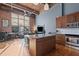 Open concept kitchen with island and stainless steel appliances at 500 N Duke St # 56-207, Durham, NC 27701