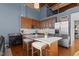 Modern kitchen with wood cabinets, granite counters, and island at 500 N Duke St # 56-207, Durham, NC 27701
