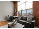 Spacious living area with exposed brick and large windows at 500 N Duke St # 56-207, Durham, NC 27701