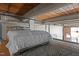 Upstairs loft bedroom with wood beams and large windows at 500 N Duke St # 56-207, Durham, NC 27701