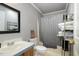 Well-lit bathroom featuring a shower with a tub and a large mirror at 5141 Nc-39 N Hwy, Henderson, NC 27537