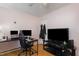 Bedroom features a desk and television with wood floors at 5141 Nc-39 N Hwy, Henderson, NC 27537