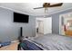 A bedroom with a ceiling fan, a television, and access to an ensuite bathroom at 5141 Nc-39 N Hwy, Henderson, NC 27537