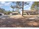 Residential home with a large yard, a carport, and additional storage structures at 5141 Nc-39 N Hwy, Henderson, NC 27537